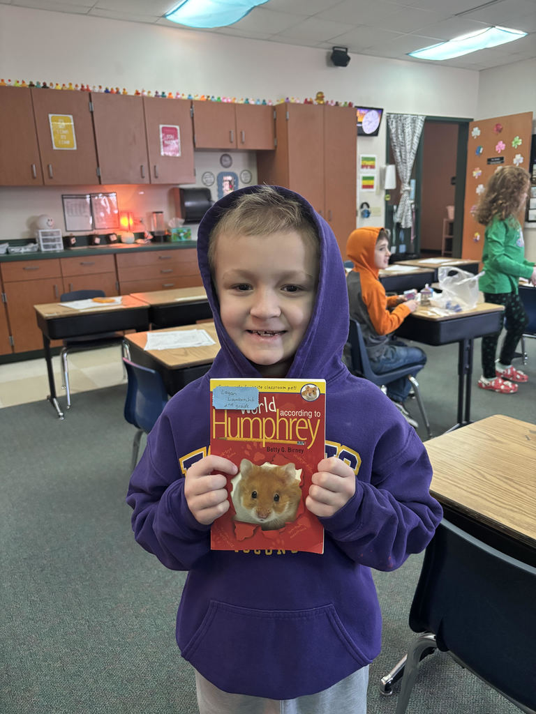 2nd grade boy holding a Humphrey Book.