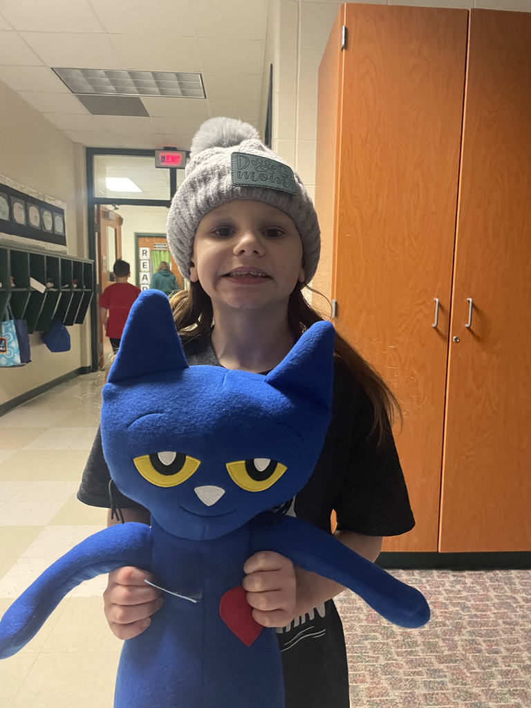 2nd grade girl holding a stuffed Pete the Cat