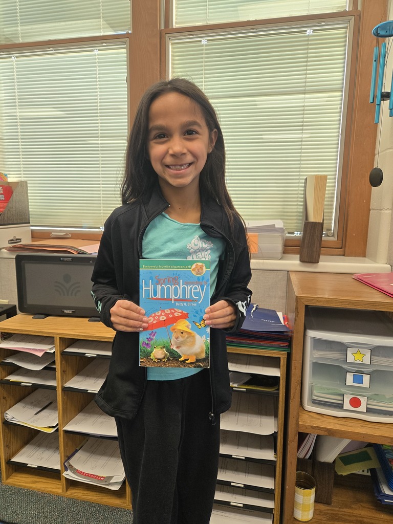 3rd grade girl holding a Humphrey Book