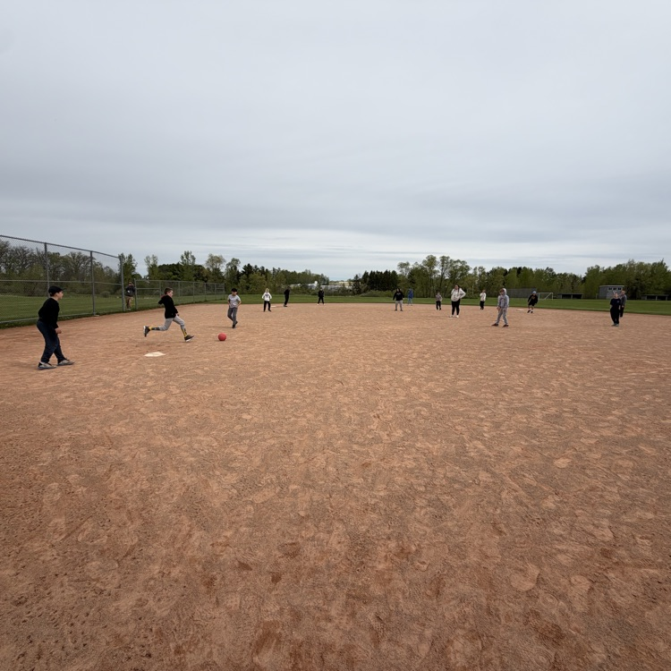 student kicking a kickball