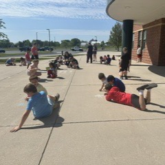 students using chalk on the sidewalk