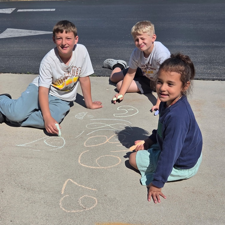 students using chalk on the sidewalk