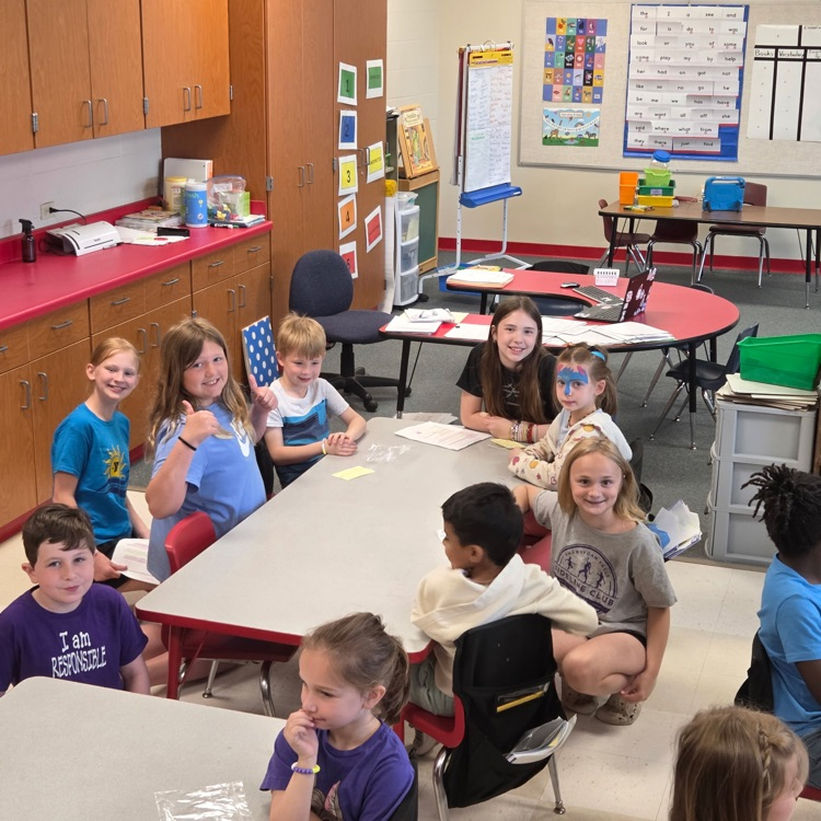 students in classroom sitting at tables