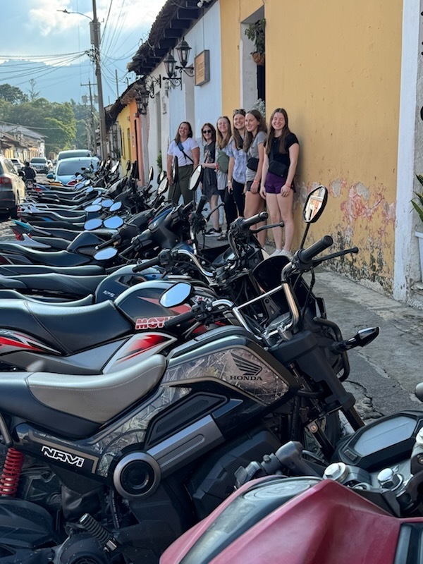 Mrs. Olig and SFHS students in Antigua, Guatemala in front of motorcycles