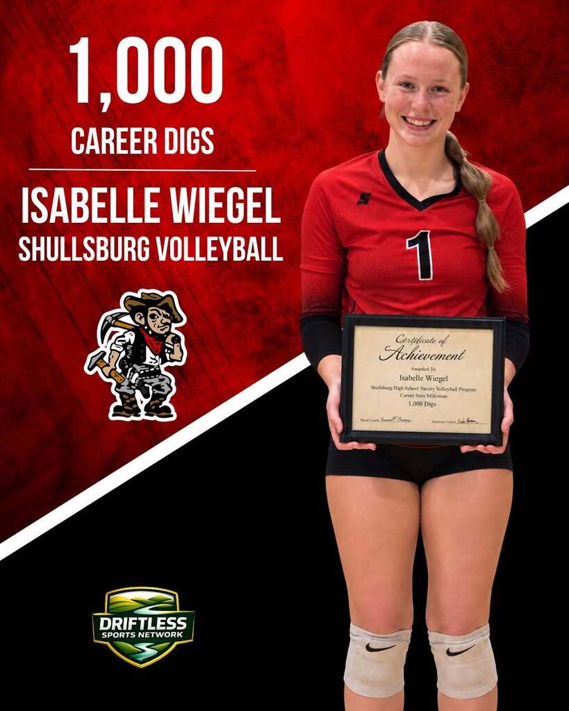 Woman in a red jersey holds a plaque that reads "1,000 Career Digs." She has a smile on her face.