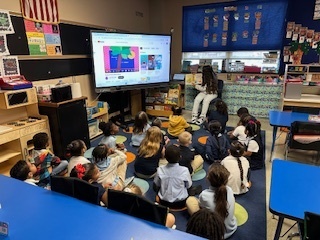 A group of students holding up a book 
