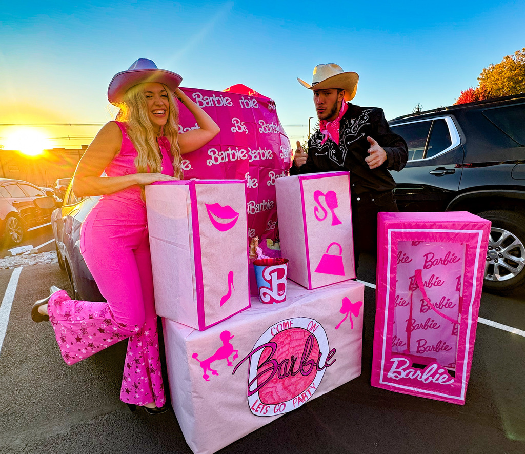 Teachers, student, and community members participating outside in a trunk or treat event