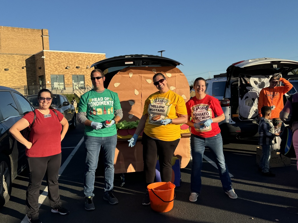 Teachers, student, and community members participating outside in a trunk or treat event