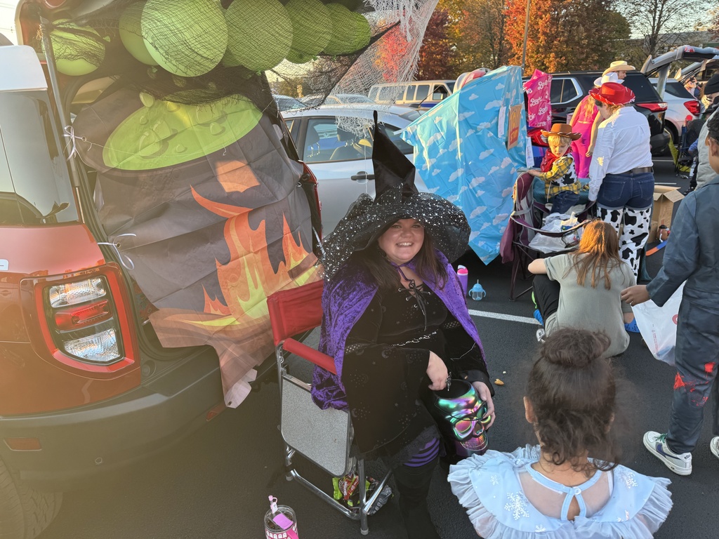 Teachers, student, and community members participating outside in a trunk or treat event