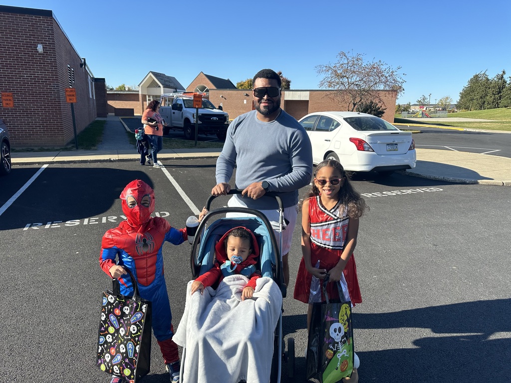 Students and families having fun at their trunk or treat event outside