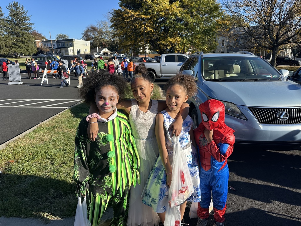 Students and families having fun at their trunk or treat event outside
