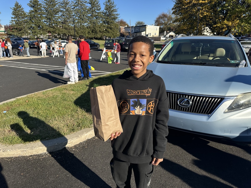 Students and families having fun at their trunk or treat event outside