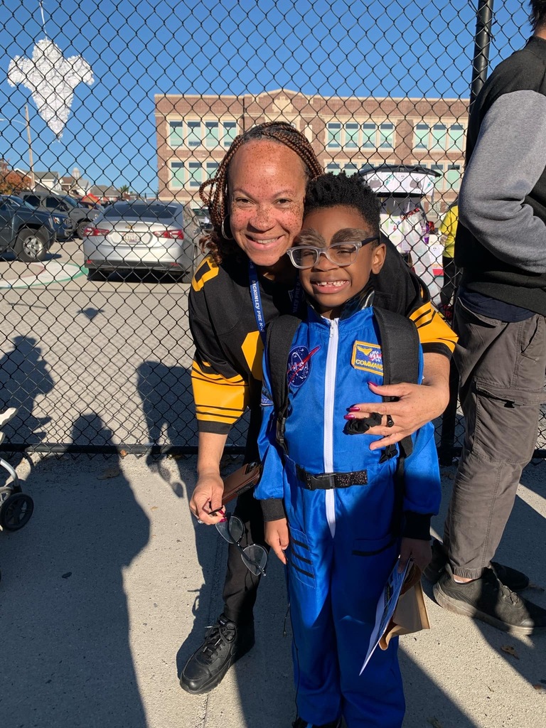 Students and families having fun at their trunk or treat event outside