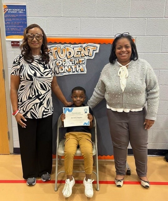 Principal Love and Dr. Berry with a student