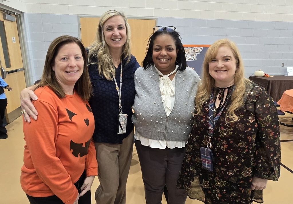 Dr. Berry with staff smiling in the cafeteria
