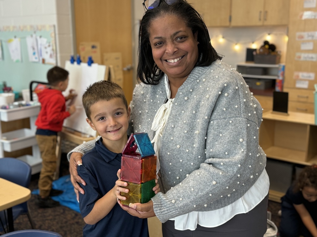 Dr. Berry with student holding a toy house