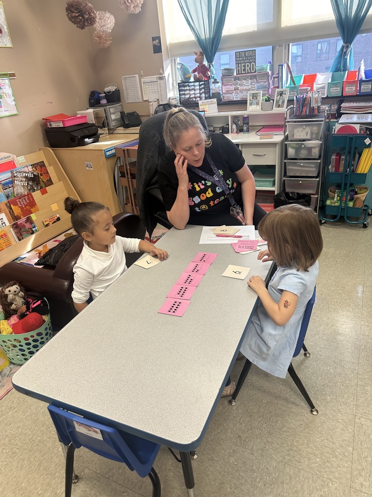 Students participating in a small group activity with their teacher