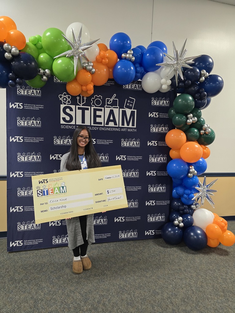 Student holding up a scholarship award