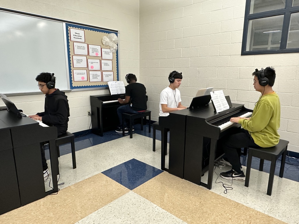 Students using new piano equipment