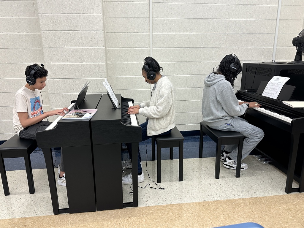 Students using new piano equipment
