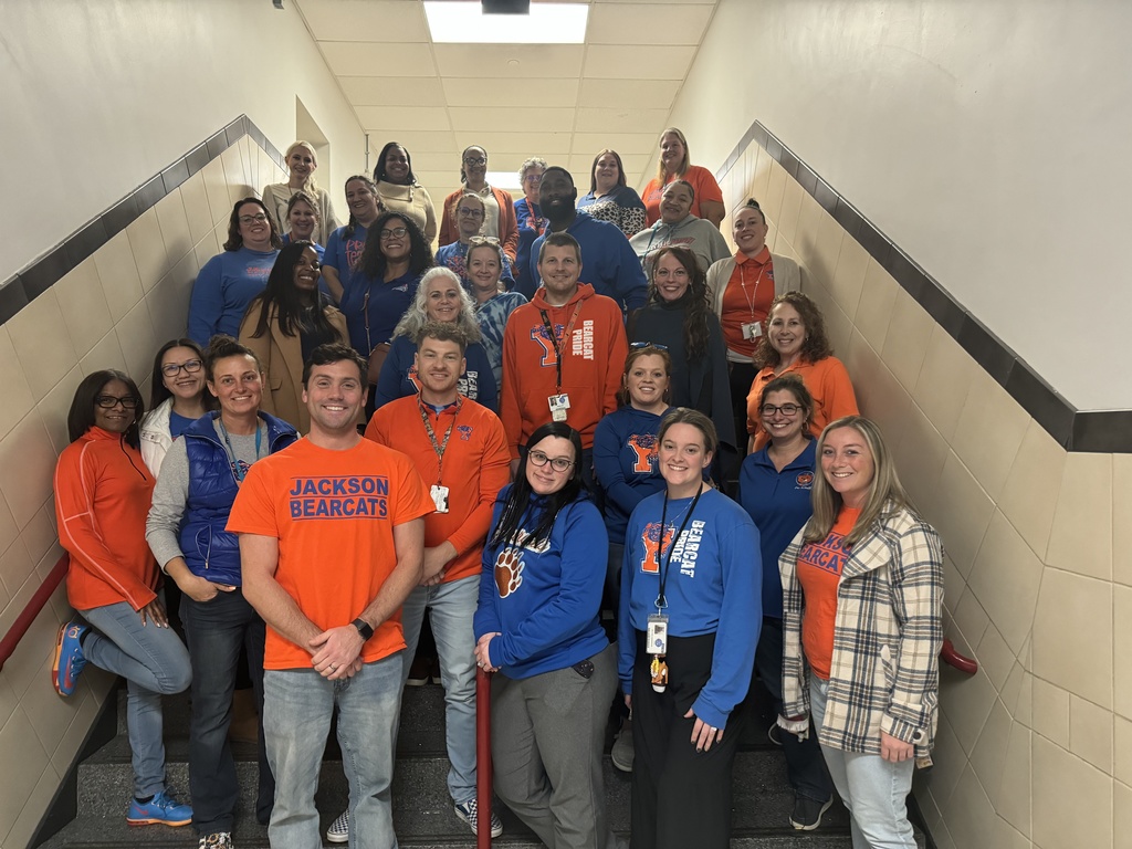 staff smiling on a staircase