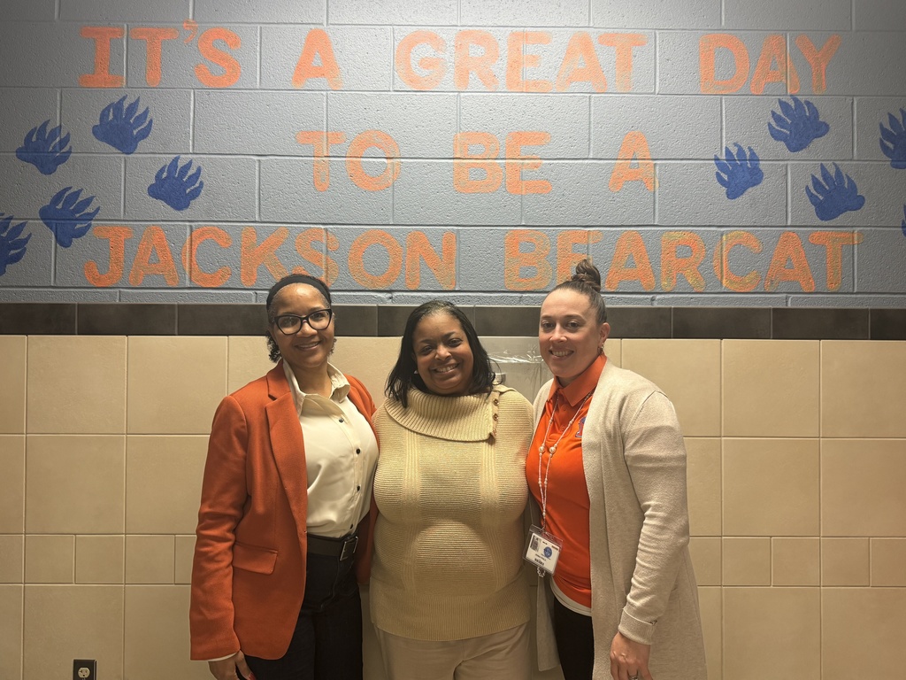 Staff smiling in a hallway
