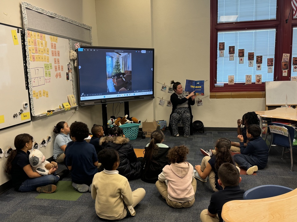 Photo of teacher reading to students