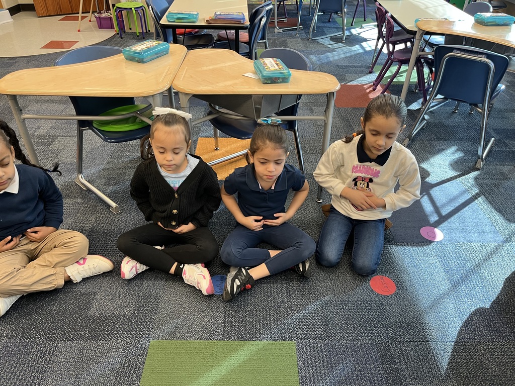 Group of students touching their stomachs 