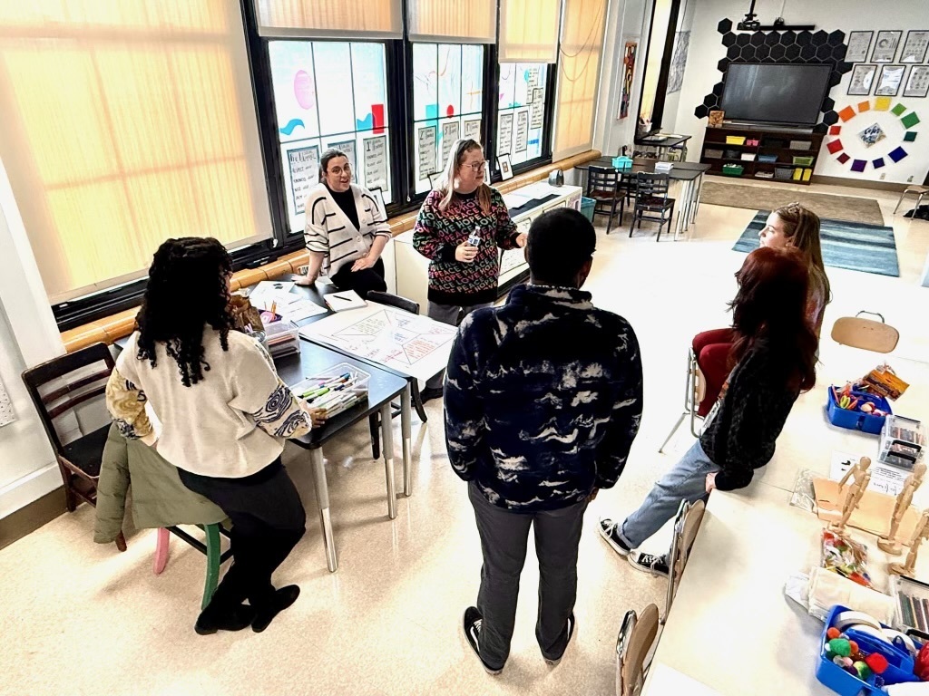 Group of people standing in a circle 