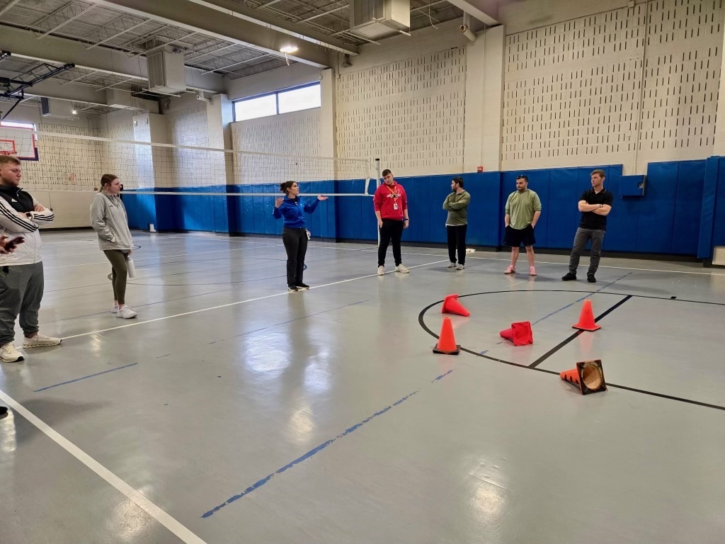 Group of people standing in a gymnasium 