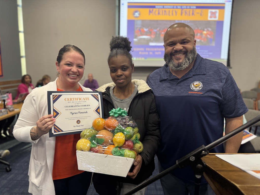 Three people standing and smiling