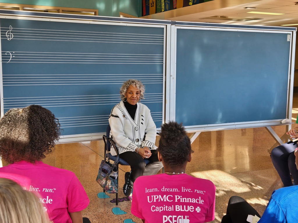 Group of students having a discussion with an adult 