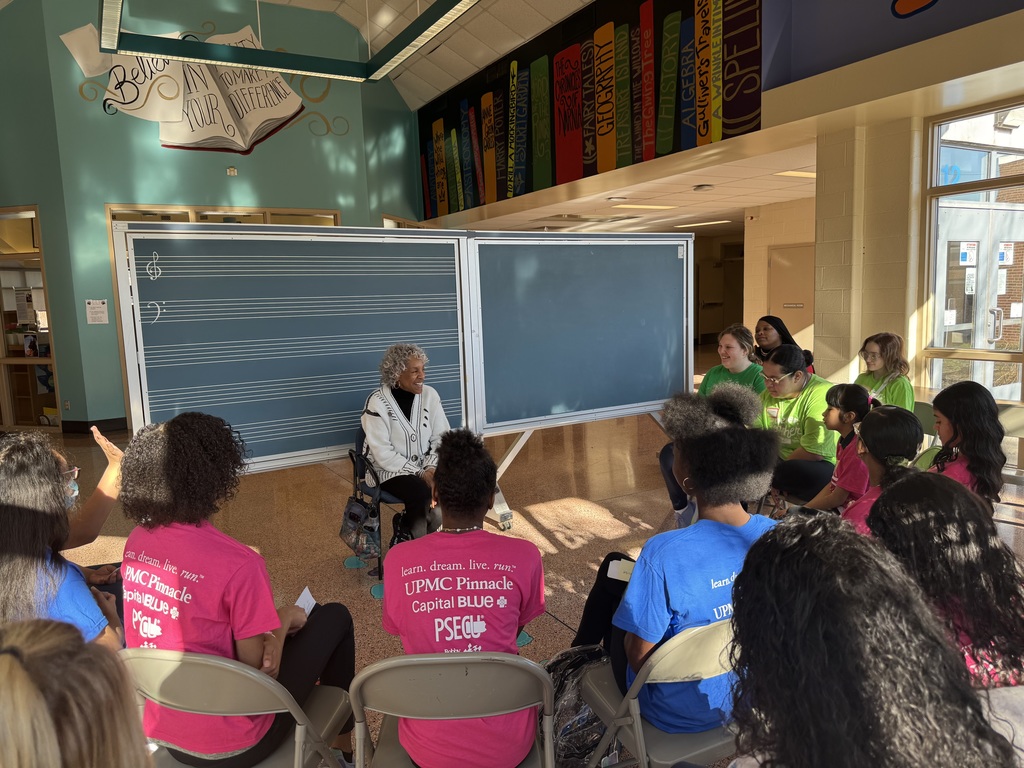 Group of students having a discussion with an adult