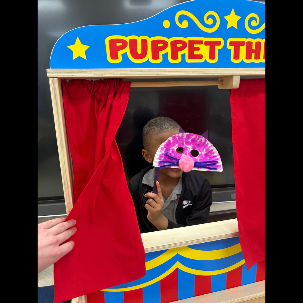 Student holding up a mask 