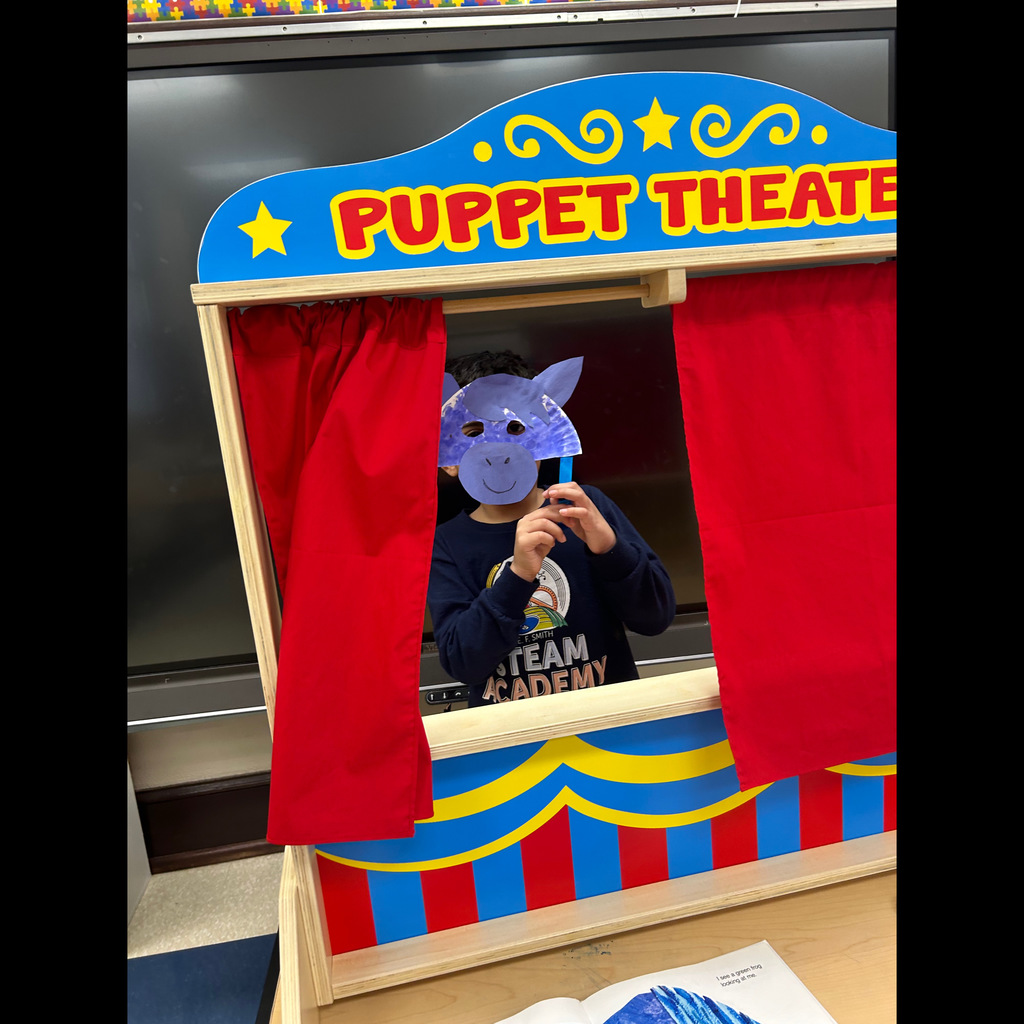 Student holding up a mask 