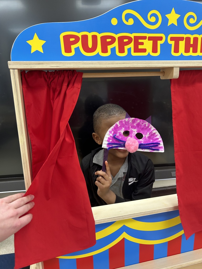 Student holding up a mask