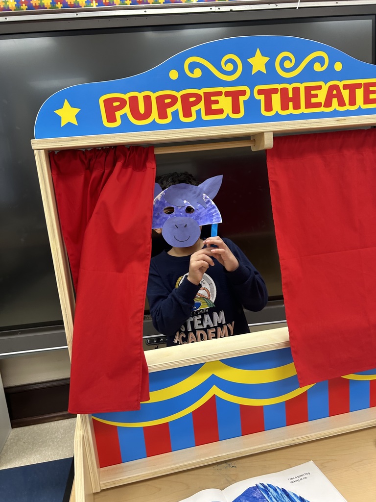 Student holding up a mask