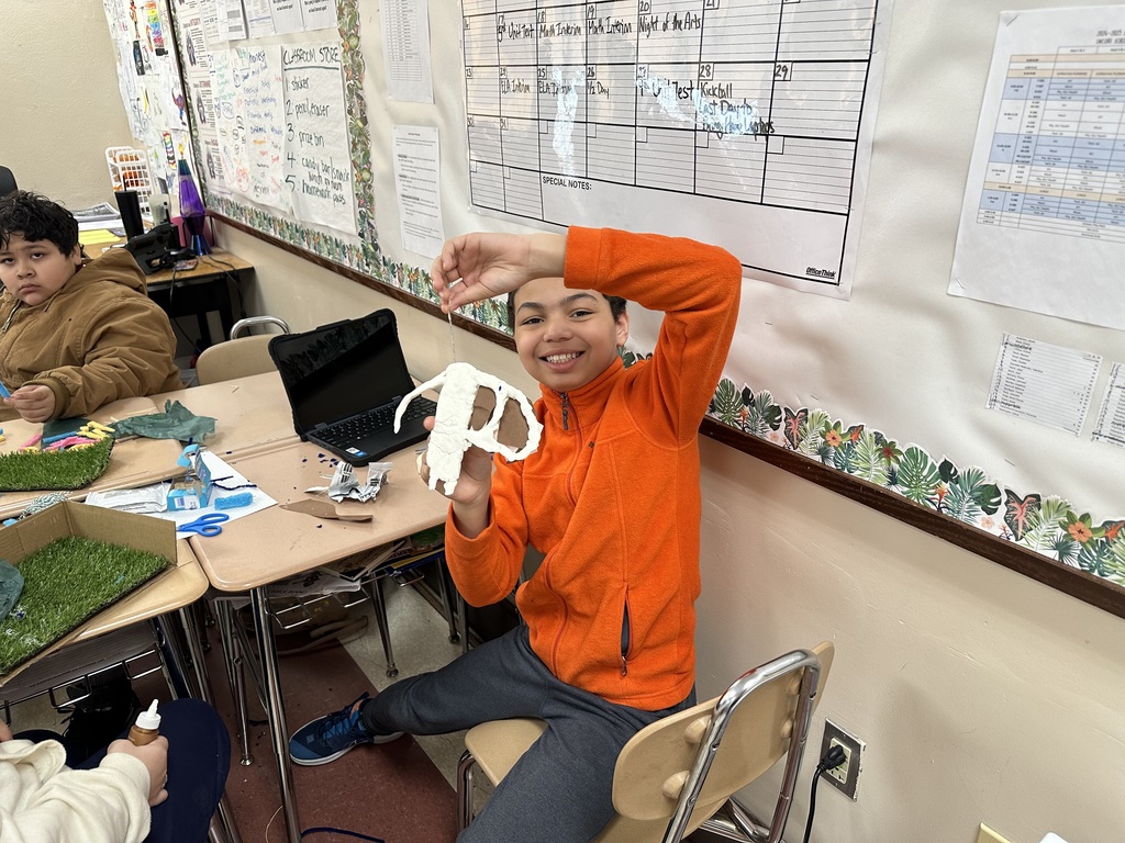 A student holding up a project