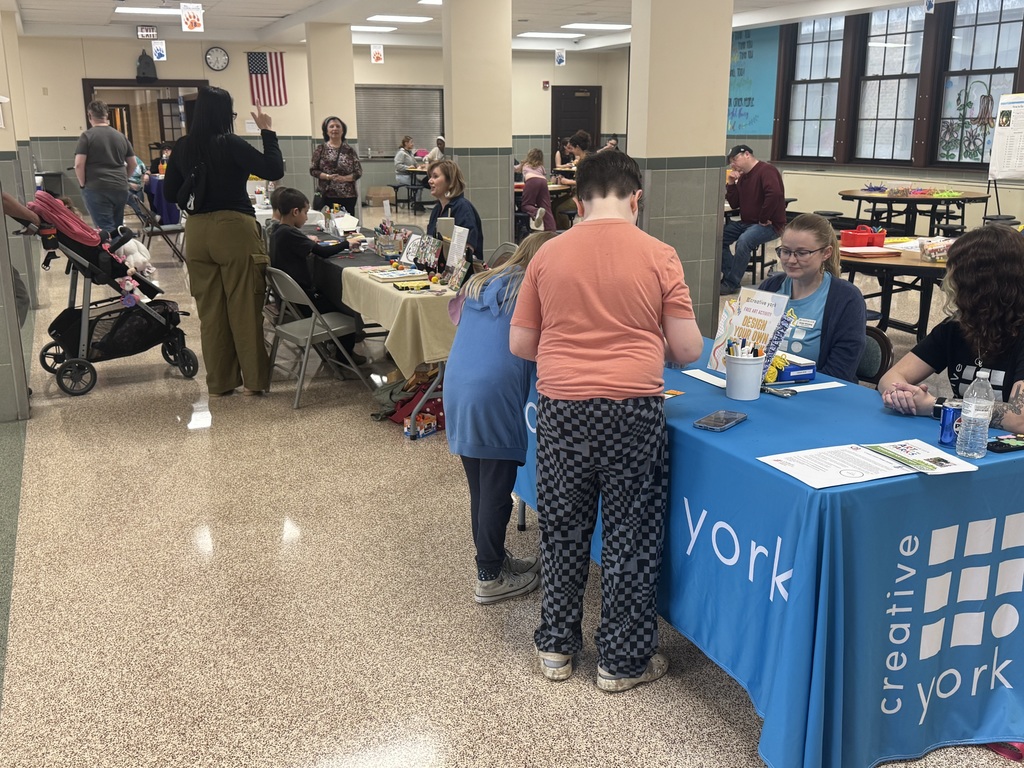People standing and sitting in a room with tables