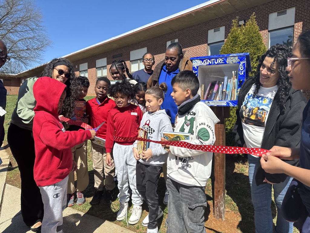 A student cutting a ribbon