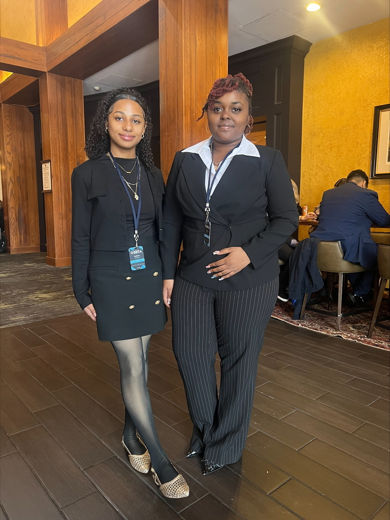 Two students standing and posing