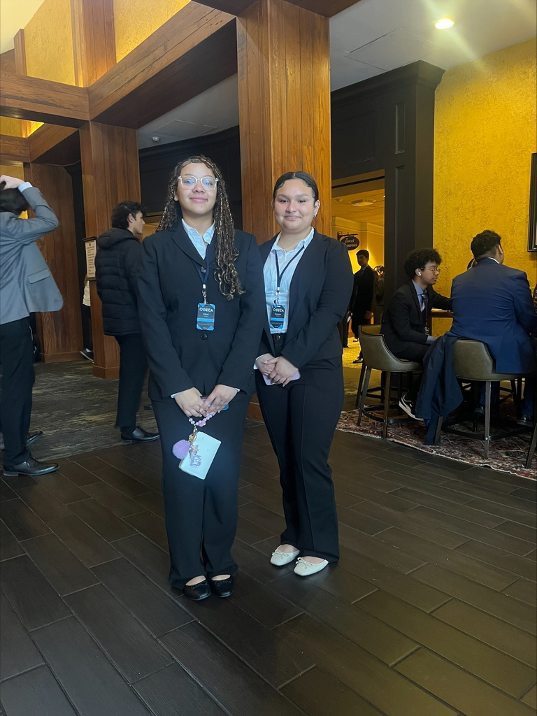 Two students standing and posing