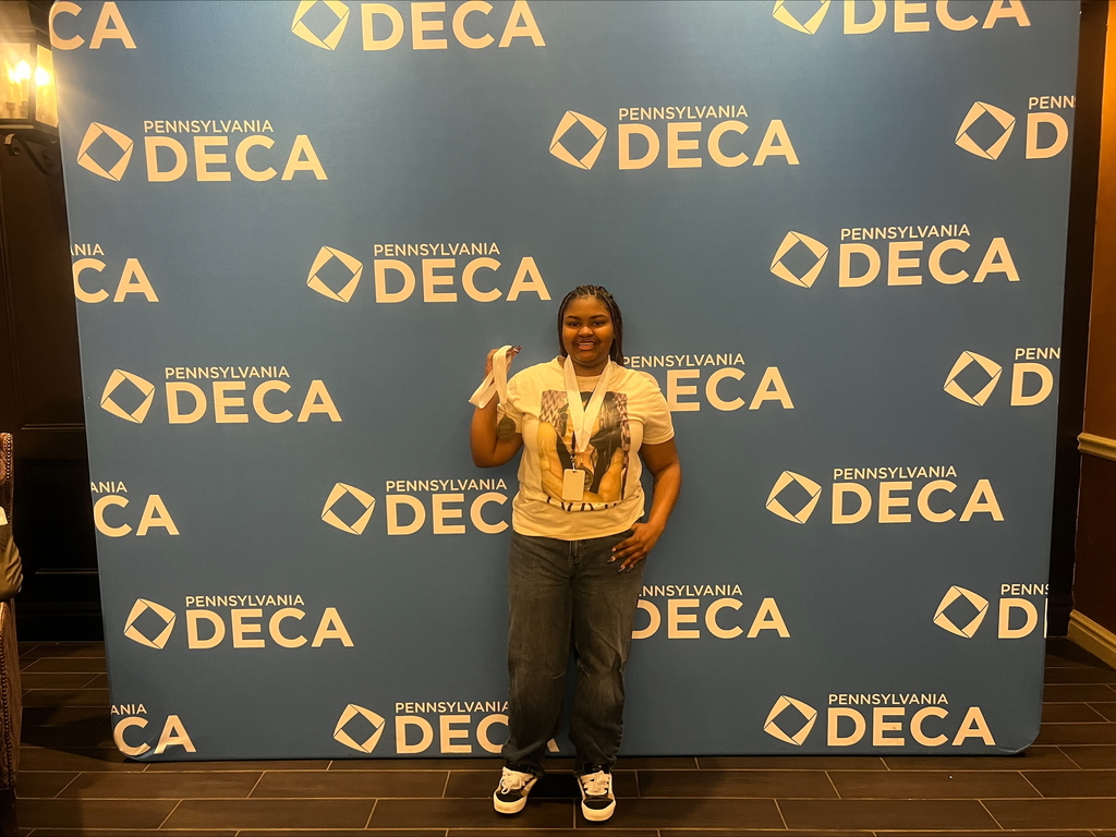 A student holding up a medal