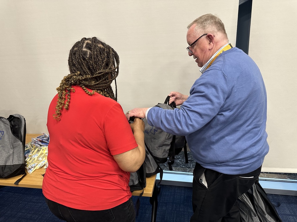 Two people working on bookbags