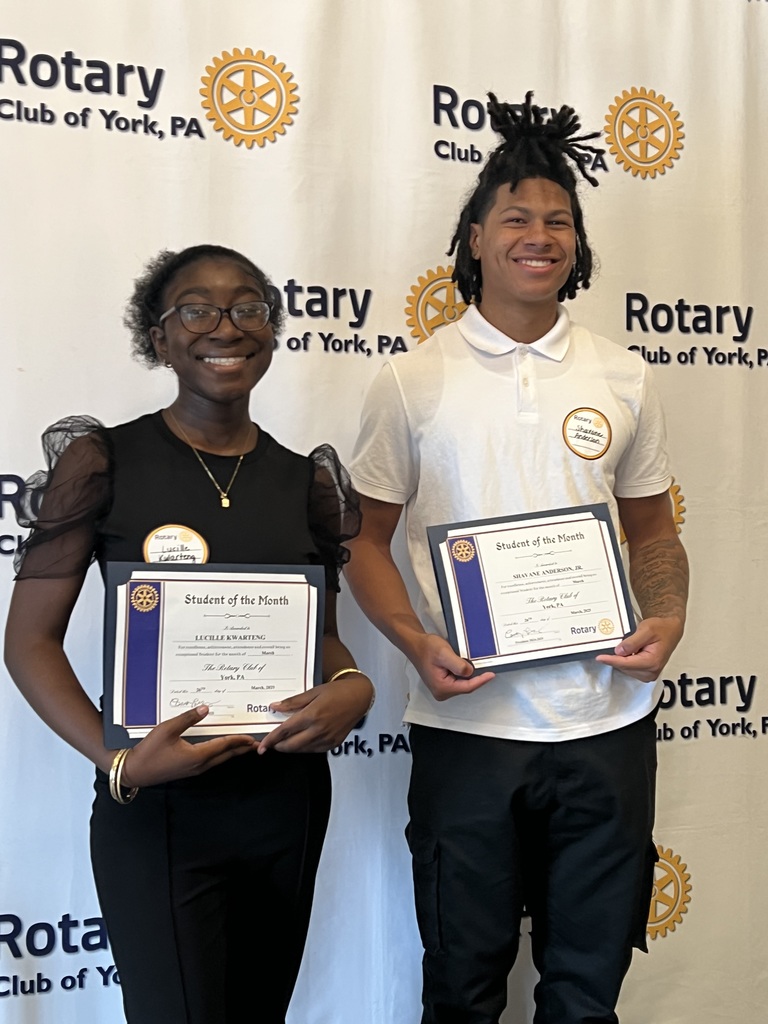 Two people smiling and holding up certificates