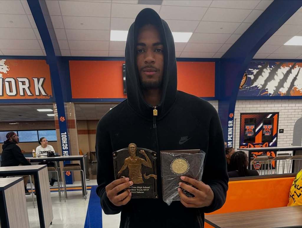 A person holding up an award