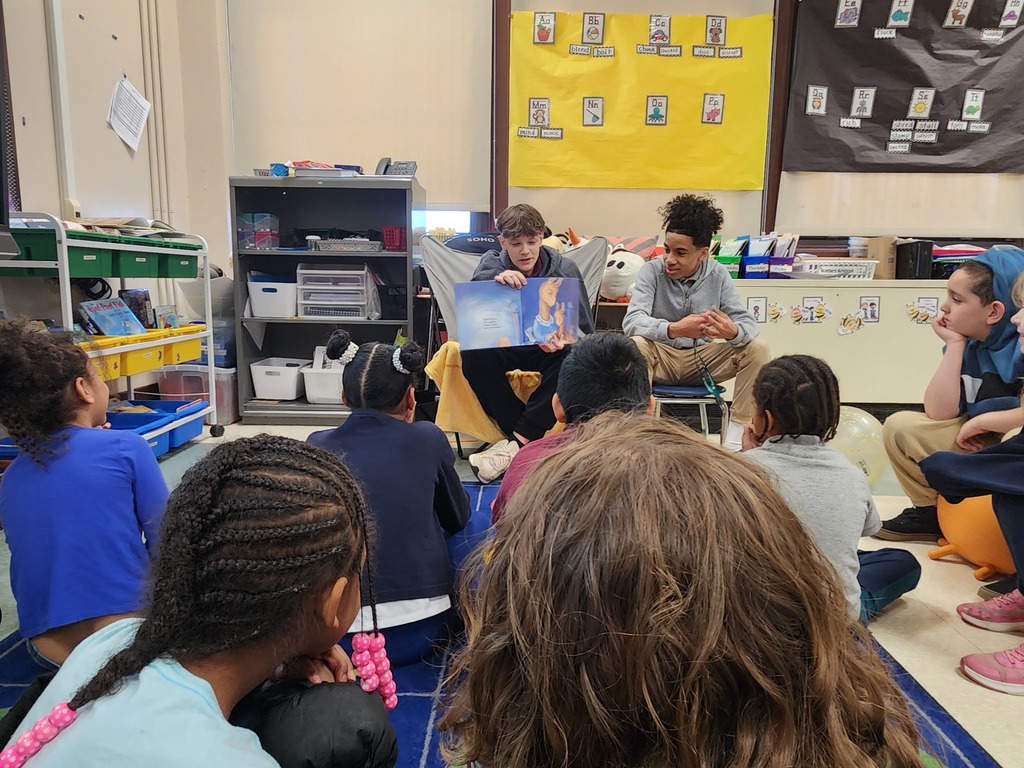 Students reading to other students 