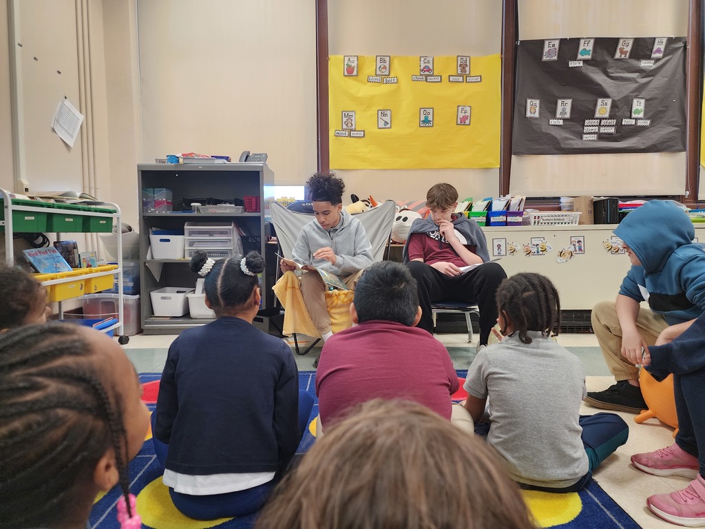 Students reading to other students 