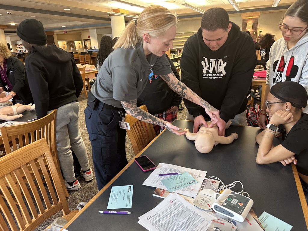 Students performing CPR on a dummy