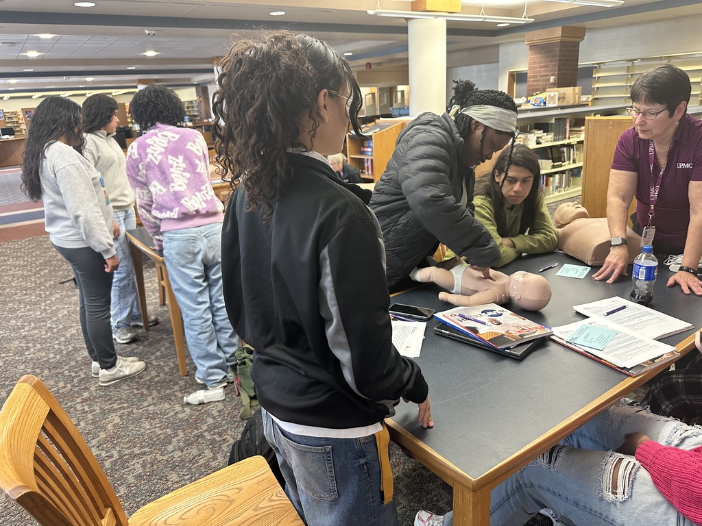 Students performing CPR on a dummy